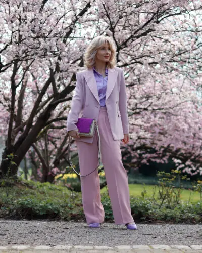 Woman in pink suit with cherry blossoms.