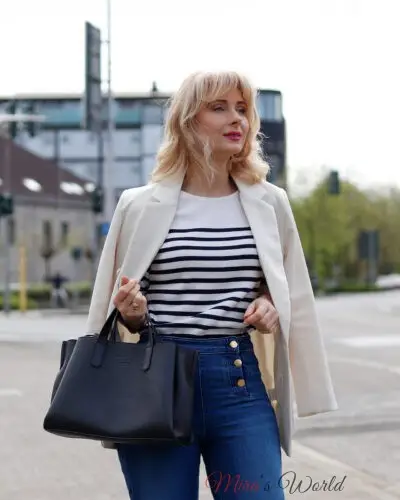 Woman in chic casual outfit with striped top.